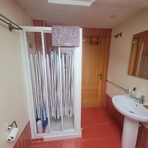 a bathroom with a shower and a sink at Ático Felechosa loft in Felechosa +16 photos