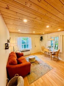 a living room with a couch and a table at Sunshine Bungalow in Salmon Arm