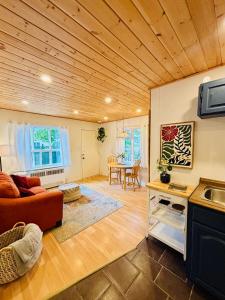 a living room with a couch and a table at Sunshine Bungalow in Salmon Arm +6 photos