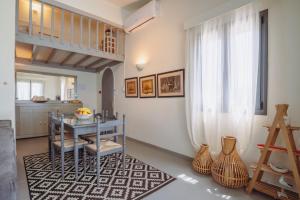 a dining room with a table and a window at Villa Filokalia With Exceptional View - Happy Rentals in Kastro Kyllini +41 photos
