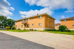 a large brick building on the side of a street at Central Menomonee Falls Condo WFH Friendly in Menomonee Falls