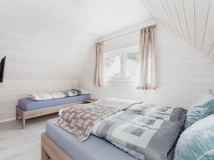 a bedroom with two beds and a window at Cottage in Pobierowo near Baltic Beach in Pobierowo