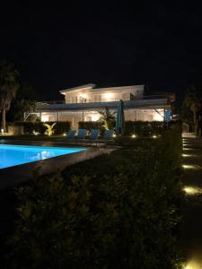 a villa with a swimming pool at night at SUNSEA - Enjoy Your Family in Capo Vaticano
