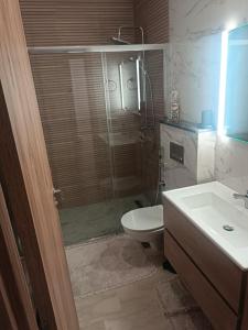 łazienka z prysznicem, toaletą i umywalką w obiekcie Élégant appartement moderne au cœur d Agadir Bay w mieście Agadir