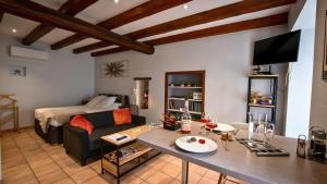 a living room with a couch and a table at Le Petit Mona Elowen in Civaux