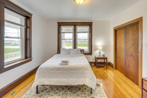 a bedroom with a large bed and two windows at Hike, Shop and Explore Apt 1 Mi to Dtwn Lancaster! in Lancaster