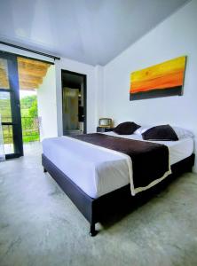 a bedroom with a large bed in a room at Betania Alojamiento Rural Quindío Eje Cafetero espectacular! in Circasia
