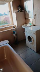 a bathroom with a washing machine and a sink at Traumhaft schöne Unterkunft am Elbe Radweg, See  +14 photos