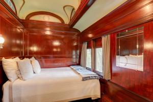 a bedroom with a bed in a wooden room at The Presidential Stay, Converted Railcar in DuBois in Adrian Furnace