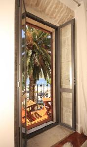 an open door to a balcony with a view of the ocean at San Teodoro Boutique Hotel in Korčula