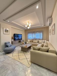 a large living room with couches and a tv at Cozy apartment Beach and Souk within walking distance in Tangier