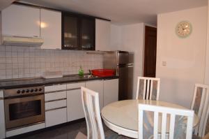 a kitchen with a table and a table and chairs at Apartment Borna in Baška