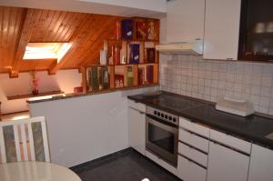 a kitchen with white cabinets and a stove top oven at Apartment Borna in Baška