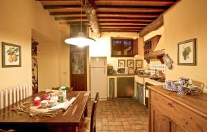 a kitchen with a wooden table and a counter top at Beautiful Apartment In Casole D'elsa in Gallena
