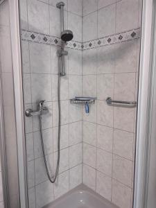 a bathroom with a shower with a sink at Gemütliche Wohnung an der Antoniuslinde im Kurort in Erwitte +20 photos