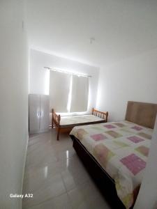 Ένα ή περισσότερα κρεβάτια σε δωμάτιο στο Casa aconchegante-Pontal Norte