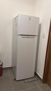 a white refrigerator sitting in a room at Casa Inga in Asuncion
