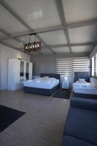 a large room with two beds and a couch at Iskele Royal Sun Long Beach penthouse in Iskele