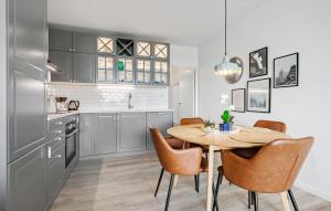 a kitchen with a table and chairs in a room at Awesome Apartment In Fanø With Sauna in Fanø