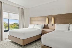 a hotel room with two beds and a window at Residence Inn by Marriott Melville in Melville +41 photos