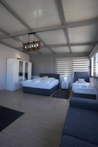 a large room with two beds and a couch at Iskele Royal Sun Long Beach penthouse in Iskele +11 photos