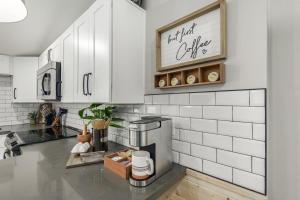 a kitchen with white cabinets and a counter top at Glenwillow home - minutes from Cardinals Stadium! in Glendale