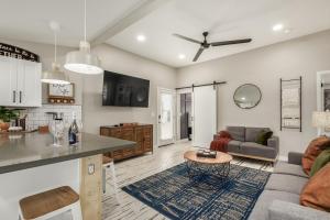 a kitchen and living room with a couch and a table at Glenwillow home - minutes from Cardinals Stadium! in Glendale