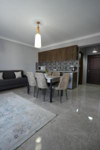 a living room with a table and some chairs at Iskele Royal Sun Long Beach penthouse in Iskele