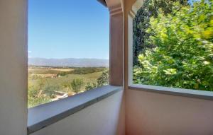 an open window with a view of a field at Pet Friendly Home In Figline Valdarno in Lucolena in Chianti +15 photos