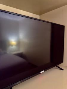 a large flat screen tv sitting on a wall at Hotel La Mansión 