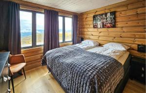 a bedroom with a bed in a room with wooden walls at Nice Home In Gol With Sauna in Holtegard