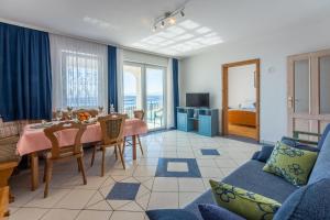 a living room with a table and a couch at Apartments Bozana in Dramalj