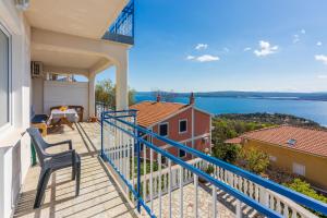 a balcony of a house with a view of the water at Apartments Bozana in Dramalj