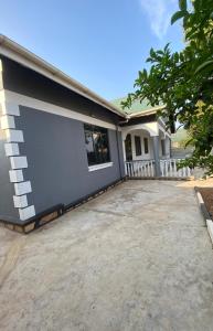 a house with a driveway in front of it at Paradise pathways lweza in Kitende