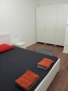 a room with a bed with two towels on it at Pristhine Stay Inn 21 in Prishtinë
