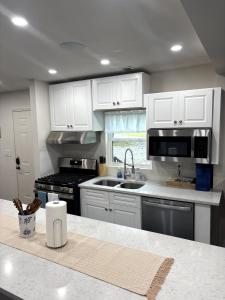 a kitchen with white cabinets and a counter top at The Lofted Retreat in Newnan