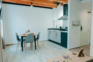 a kitchen with a table and chairs in a room at Romantic Boutique Apartment 2 in Villajoyosa +6 photos