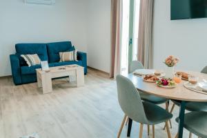 a living room with a blue couch and a table at Romantic Boutique Apartment 2 in Villajoyosa