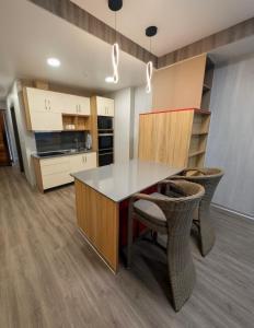 a kitchen with a table and chairs in a room at ICHA Apartments in Suva