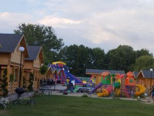 a playground with slides and play equipment in a yard at Perła Brenno in Brenno