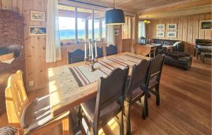 a dining room with a wooden table and chairs at Awesome Home In Eggedal With Sauna in Eggedal
