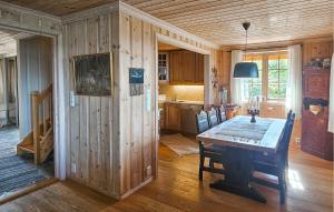 a kitchen and dining room with a table and chairs at Awesome Home In Eggedal With Sauna in Eggedal
