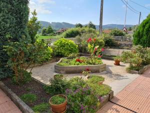 einen Garten mit Blumen und Pflanzen auf einem Gehweg in der Unterkunft Gran casa rural con Finca de 4000 m2 in Quijano
