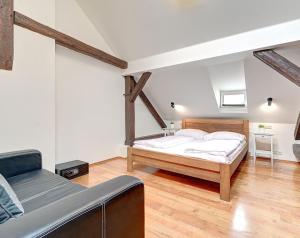 a bedroom with a bed and a couch in it at PENTHOUSe SUITE ABOVE in Prague