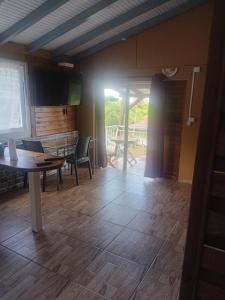a living room with a table and chairs and a patio at Appartement le carbet in Capesterre-Belle-Eau
