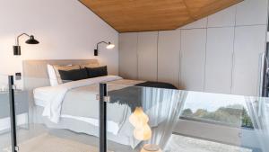 a bedroom with a bed and a glass table at Studios del Susana - Dúplex Únicos y Exclusivos in Ushuaia