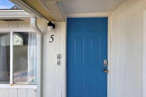 a blue door on the side of a house at Sea Haven Motel Unit .5 in Rockaway Beach