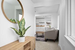 a living room with a mirror and a table with a plant at Inn at Rockaway Beach Unit #5 in Rockaway Beach