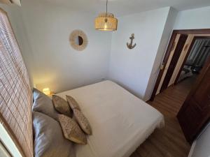 a bedroom with a bed and a couch in a room at "Ancla-Blanca" Ocean View Duplex 2min Beach Cabo Roig - La Zenia in Orihuela Costa