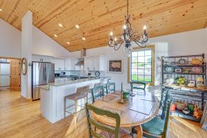a kitchen and dining room with a wooden ceiling at Walk to Dtwn Syracuse Private Lake-View Home in Syracuse